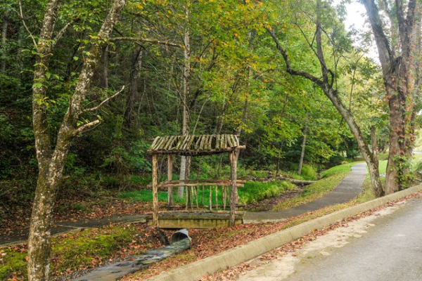 bridge over a stream on the nature trail at alpine something blue a 1 bedroom cabin rental located in pigeon forge