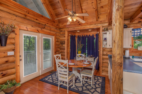 dining table with seating for four at alpine something blue a 1 bedroom cabin rental located in pigeon forge