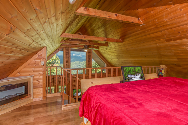 Fireplace and mountain view in the loft bedroom at Cupid's Crossing, a 1 bedroom cabin rental located in Pigeon Forge