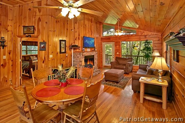 dining room table with seating for four at always together forever a 1 bedroom cabin rental located in pigeon forge