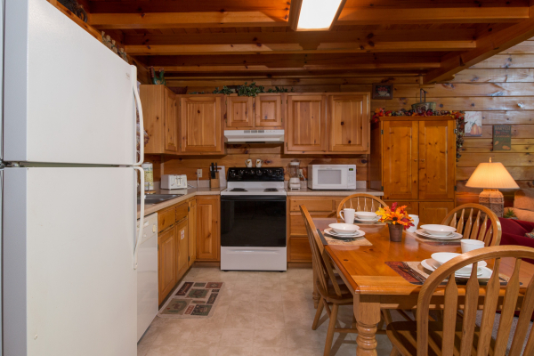 Kitchen with white appliances at A Honeymoon Haven, a 1 bedroom cabin rental located in Gatlinburg