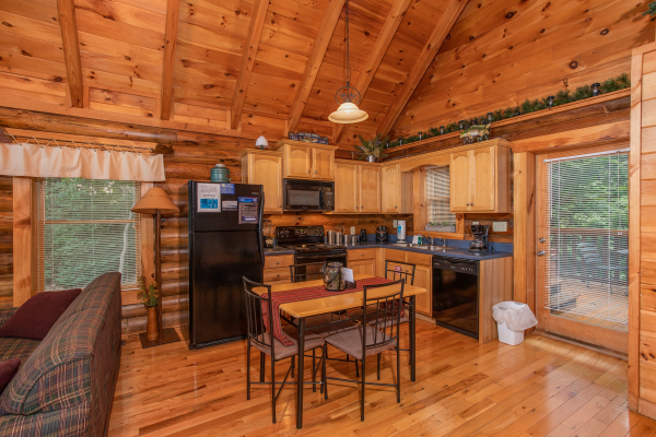 eat in kitchen with seating for four at alpine sunset thrill a 1 bedroom cabin rental located in pigeon forge