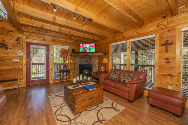 Living room with fireplace and TV at Hidden Joy, a 1 bedroom cabin rental located in Gatlinburg