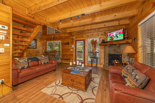 Fireplace and TV in the living room at Hidden Joy, a 1 bedroom cabin rental located in Gatlinburg