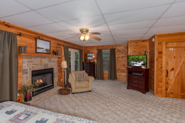 Bedroom with a fire place and television at A View for You, a 1 bedroom cabin rental located in Pigeon Forge