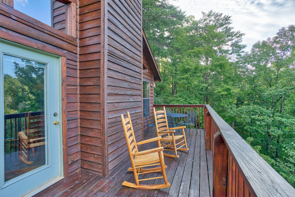 Rocking chairs on a deck at A View for You, a 1 bedroom cabin rental located in Pigeon Forge