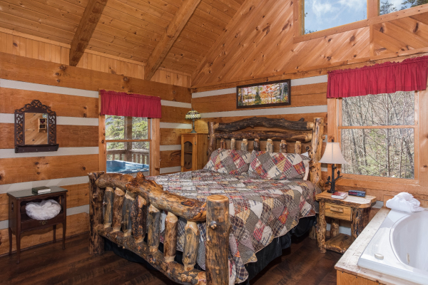 Bedroom with a loge bed and jacuzzi at A Postcard View, a 1 bedroom cabin rental located in Pigeon Forge