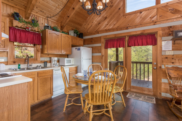 Dining table with seating for four in the kitchen at A Postcard View, a 1 bedroom cabin rental located in Pigeon Forge