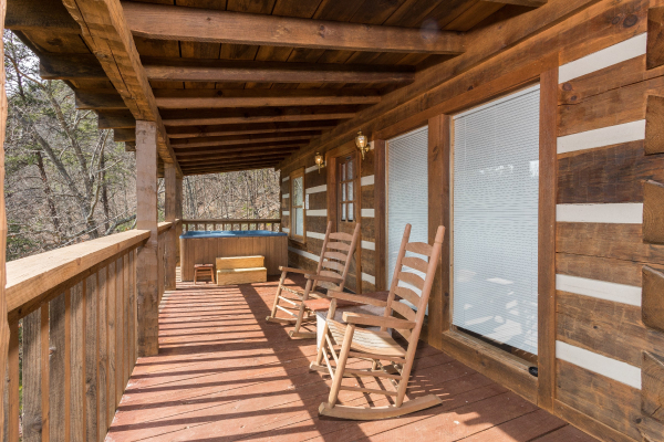 Rocking chairs on a covered deck at A Postcard View, a 1 bedroom cabin rental located in Pigeon Forge