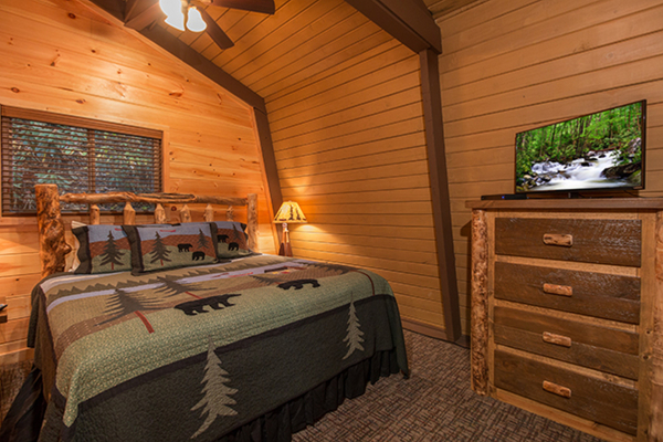 Bedroom with king bed and TV on the second floor at Without A Paddle, a 3 bedroom cabin rental located in Gatlinburg
