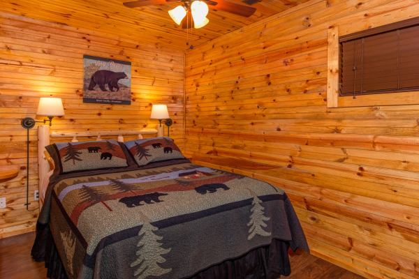 Bedroom with two lamps in cabin 1 at The Settlement, a 10 bedroom cabin rental located in Pigeon Forge