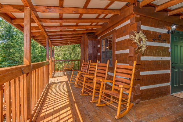 Porch with rocking chairs at cabin 3 at The Settlement, a 10 bedroom cabin rental located in Pigeon Forge