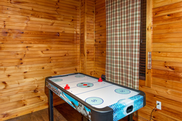 Air hockey in the cabin 1 game room at The Settlement, a 10 bedroom cabin rental located in Pigeon Forge