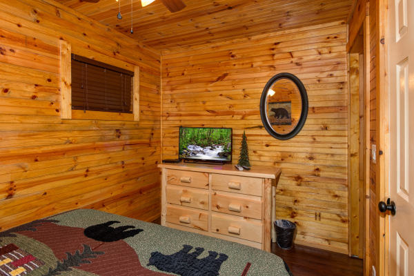Dresser and TV in the bedroom at cabin 1 at The Settlement, a 10 bedroom cabin rental located in Pigeon Forge