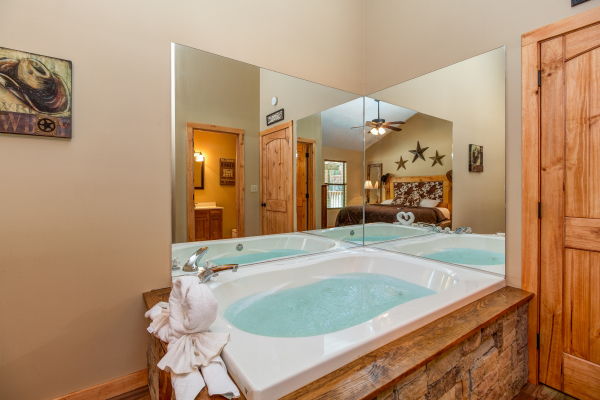 Jacuzzi in a bedroom at cabin 2 at The Settlement, a 10 bedroom cabin rental located in Pigeon Forge