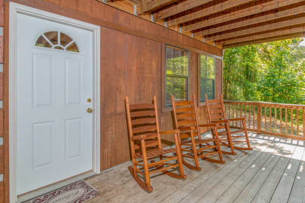 Porch with rocking chairs at cabin 2 at The Settlement, a 10 bedroom cabin rental located in Pigeon Forge