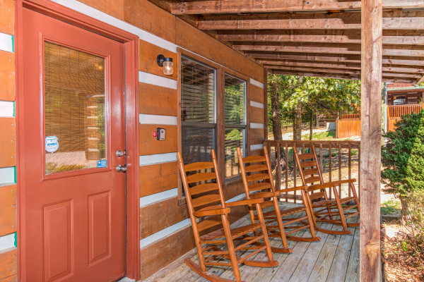 Porch with rocking chairs at cabin 2 at The Settlement, a 10 bedroom cabin rental located in Pigeon Forge