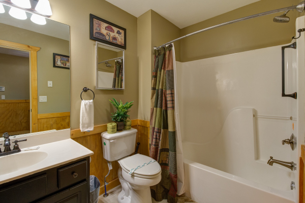 Bathroom with a tub and shower at The Settlement, a 10 bedroom cabin rental located in Pigeon Forge