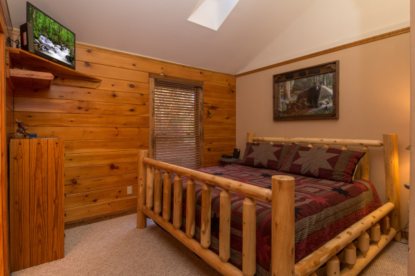 Bedroom with a log bed and TV at Just for Fun, a 4 bedroom cabin rental located in Pigeon Forge