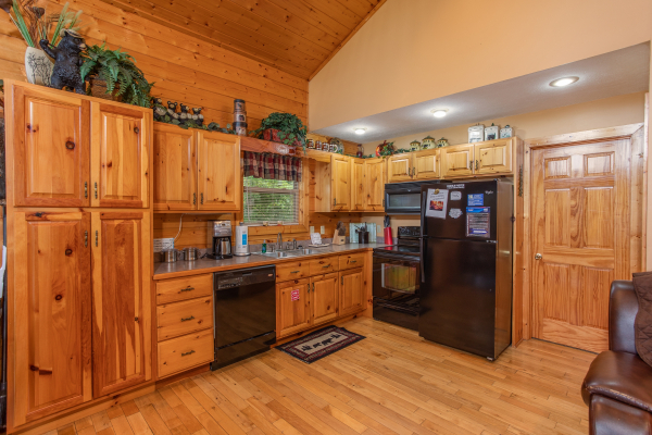 Custom kitchen with black appliances at Into the Mist, a 3 bedroom cabin rental located in Pigeon Forge
