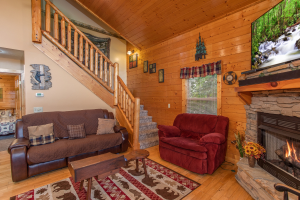 Living room with an oversized chair and couch at Into the Mist, a 3 bedroom cabin rental located in Pigeon Forge