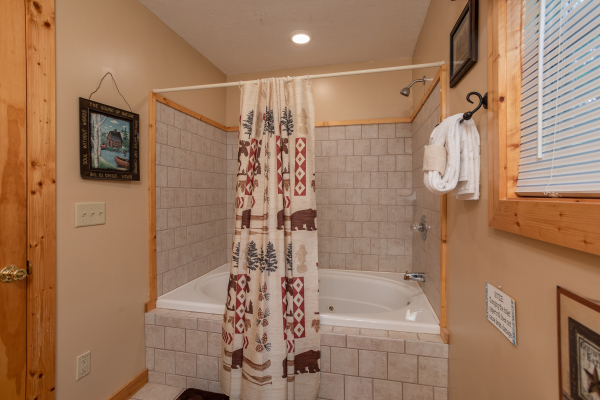 Bathroom with a jacuzzi tub and a shower at Into the Mist, a 3 bedroom cabin rental located in Pigeon Forge