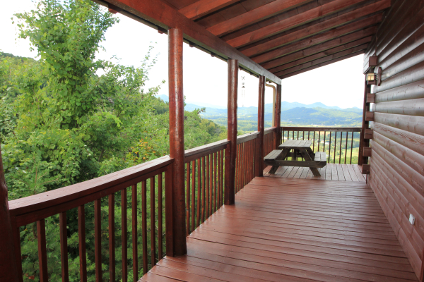 Covered deck with a picnic table at Hummingbird's Views, a 1 bedroom cabin rental located in Pigeon Forge