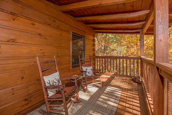 Rocking chairs on the deck at Bear Hug Hideaway, a 1-bedroom cabin rental located in Pigeon Forge