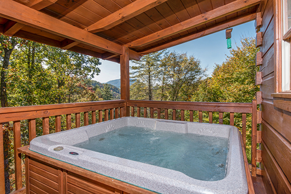 Hot tub and view at Bear Hug Hideaway, a 1-bedroom cabin rental located in Pigeon Forge