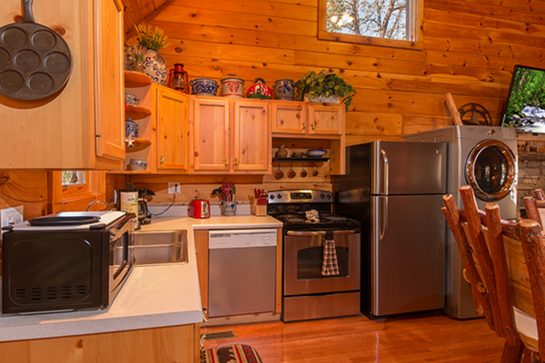 Kitchen with stainless appliances at Bear Hug Hideaway, a 1-bedroom cabin rental located in Pigeon Forge