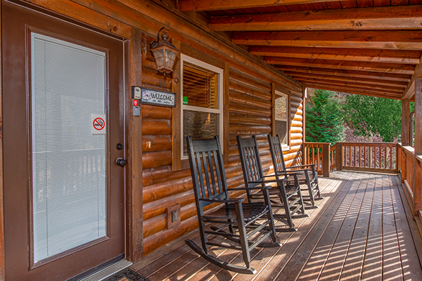 Front porch with rocking chairs at Rustic Romance, a 2 bedroom cabin rental located in Pigeon Forge