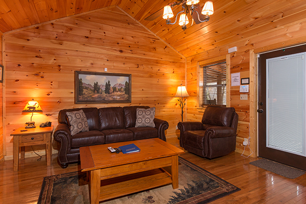 Living room with sofa and chair at Rustic Romance, a 2 bedroom cabin rental located in Pigeon Forge