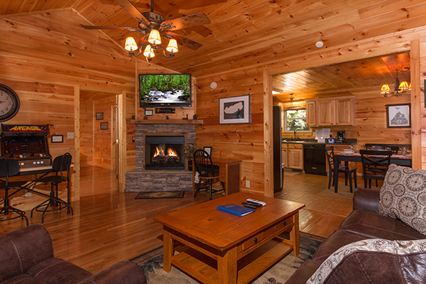 Fireplace and TV in the living room at Rustic Romance, a 2 bedroom cabin rental located in Pigeon Forge