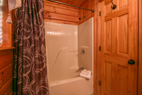 Bathroom with a tub and shower at A Beary Cozy Escape, a 1 bedroom cabin rental located in Pigeon Forge