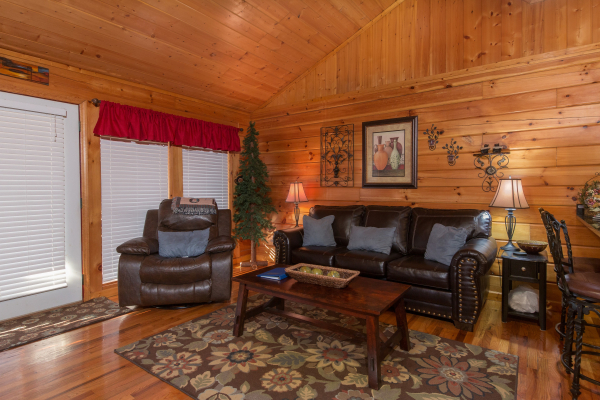 Sofa and chair in the living room at A Beary Cozy Escape, a 1 bedroom cabin rental located in Pigeon Forge