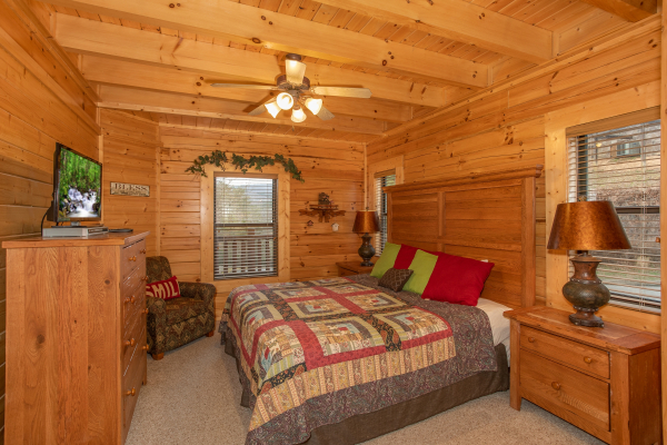 Bedroom with dresser and TV at Let the Good Times Roll, a 2 bedroom cabin rental located in Pigeon Forge