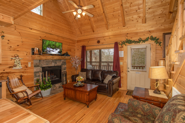 Living room with fireplace and TV at Let the Good Times Roll, a 2 bedroom cabin rental located in Pigeon Forge