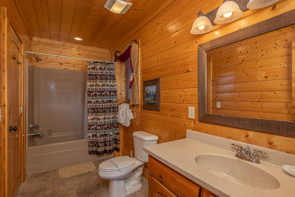 Bathroom with shower and tub combo at Grand Timber Lodge, a 5-bedroom cabin rental located in Pigeon Forge