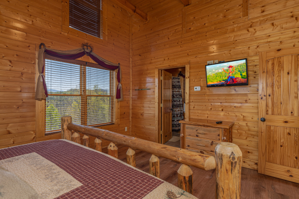 Bedroom with bathroom at Grand Timber Lodge, a 5-bedroom cabin rental located in Pigeon Forge