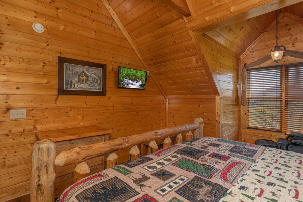 Bedroom with flat screen tv at Grand Timber Lodge, a 5-bedroom cabin rental located in Pigeon Forge