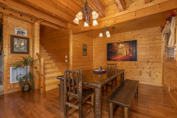 Log bench dining table  at Grand Timber Lodge, a 5-bedroom cabin rental located in Pigeon Forge