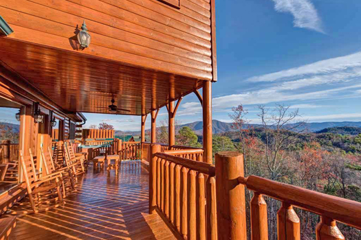 Looking across the large deck across to the Smoky Mountain Views at Grand Timber Lodge, a 5-bedroom cabin rental located in Pigeon Forge