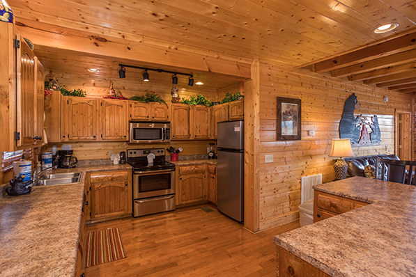 Kitchen with stainless appliances at Grand Timber Lodge, a 5-bedroom cabin rental located in Pigeon Forge