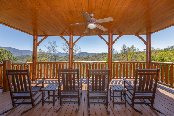 Covered deck seating at Grand Timber Lodge, a 5-bedroom cabin rental located in Pigeon Forge