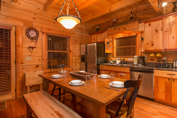 Dining table with seating for six in the kitchen at Bearfoot Paradise, a 3-bedroom cabin rental located in Pigeon Forge