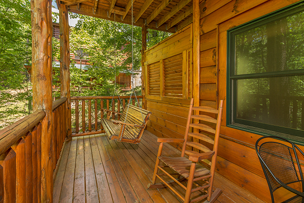 Deck with a porch swing and rocking chair at Bearfoot Paradise, a 3-bedroom cabin rental located in Pigeon Forge