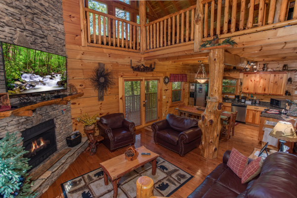 Open concept living room with a loveseat and recliner at Bearfoot Paradise, a 3-bedroom cabin rental located in Pigeon Forge