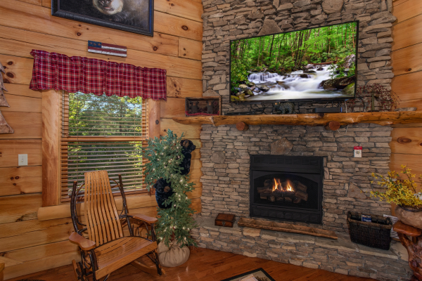 Rocker next to a fireplace with a television at Bearfoot Paradise, a 3-bedroom cabin rental located in Pigeon Forge
