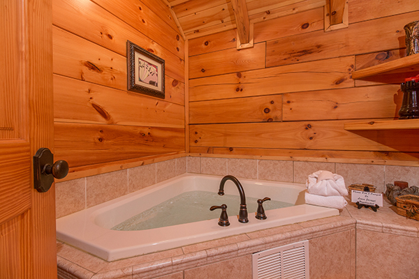 Corner jacuzzi tub in the bathroom at Bearfoot Paradise, a 3-bedroom cabin rental located in Pigeon Forge