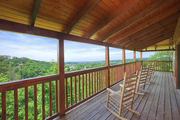 Rocking chairs on a covered deck at Pigeon Forge View, a 6 bedroom cabin rental located in Pigeon Forge